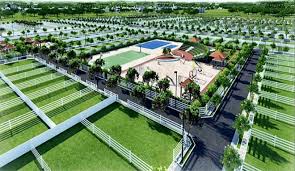 An aerial rendering of a gated community showing landscaped plots, a playground, and multi-purpose sports courts surrounded by lush greenery.