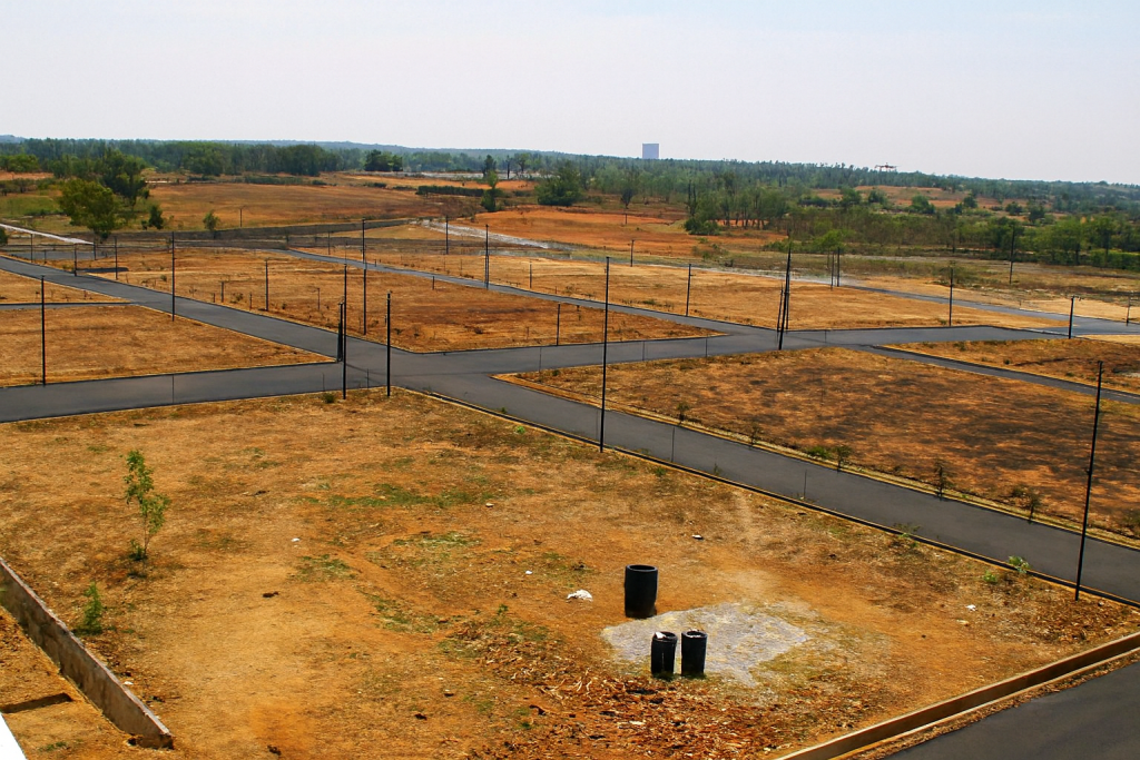 Residential plots in DLF Phase 1, Gurugram showing developed land with marked plots, internal roads, and surrounding infrastructure in a prime location.