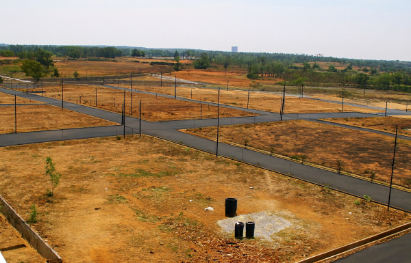 Residential plots in DLF Phase 1, Gurugram showing developed land with marked plots, internal roads, and surrounding infrastructure in a prime location.