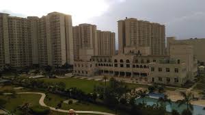 Aerial view of DLF Garden City Enclave in Sector 93, Gurugram showcasing high-rise residential towers, landscaped central greens, clubhouse, and a well-planned gated community.