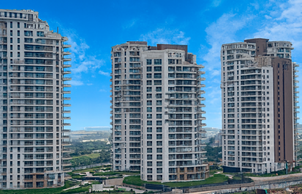 High-rise residential towers of Pioneer Urban Presidia in Sector 62, Gurugram featuring modern architecture, multiple towers, landscaped surroundings, and a premium gated community.