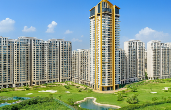 Aerial view of M3M Golf Estate in Gurugram showcasing luxury high-rise towers, landscaped golf greens, water features, and premium residential amenities.